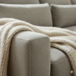 Close-up of the soft, durable chenille fabric on the armrest of the sectional sofa.