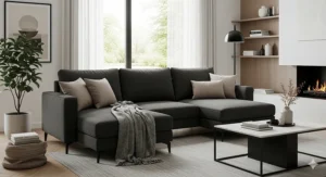Dark gray sectional sofa styled with neutral pillows and a throw blanket for a cozy feel.
