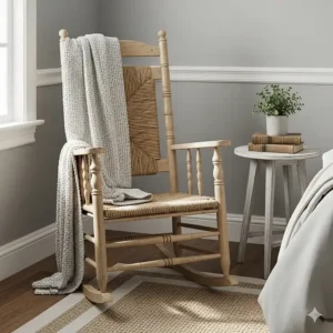 A charming farmhouse-style rocking chair with a woven seat, complementing a bedroom corner.
