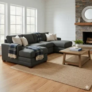Modern rustic living room featuring a dark grey farmhouse sectional sofa decorated with plaid blankets.