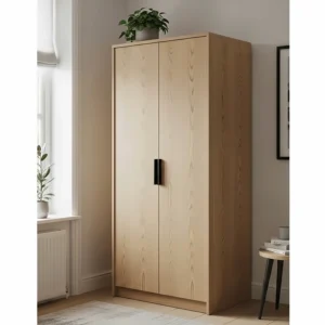 A tall, slender light ash wood armoire with two doors and matte black hardware, providing vertical storage in a small room.