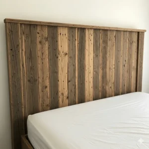 A rustic wooden headboard with vertical plank detailing, adding character to the bed.