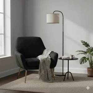 A stylish, velvet black accent chair placed in the corner of the room with a patterned throw and floor lamp.