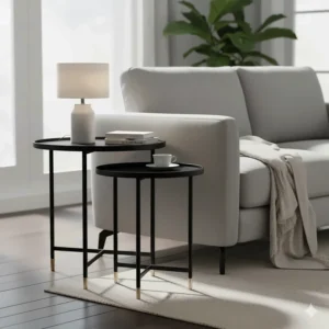 Pair of small, nesting black side tables next to a sofa, providing convenient surfaces for drinks and lamps.