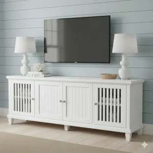 A white slatted media console or TV stand with beadboard doors, classic coastal living room furniture for media storage.