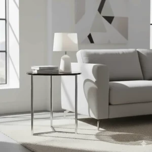 Sleek round chrome metal end table next to a sofa, adding a modern and contemporary touch to the living room furniture.