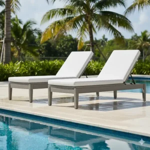 Composite poolside lounge chairs positioned next to a swimming pool, illustrating their water and chlorine resistance.