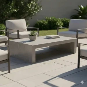 Low-profile, rectangular concrete outdoor coffee table with natural color variations, perfect for a minimalist and durable patio lounge area.