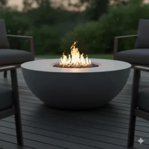 A sleek, circular gray concrete outdoor fire pit table creating a warm, contemporary ambiance on a wooden deck.