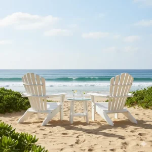 Two classic, comfortable white Adirondack chairs sitting on a sandy beach, perfect examples of relaxed coastal outdoor furniture.