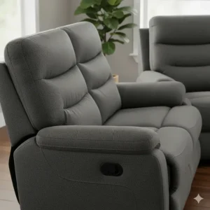 Detailed view of the plush headrests and ergonomic lumbar support on a reclining sofa and loveseat set.