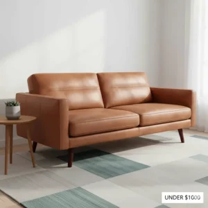 Mid-century modern leather sofa with tapered wooden legs, priced under $1000.