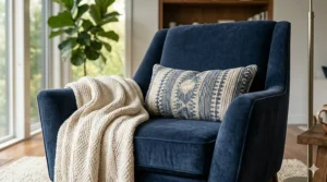 Close-up view of the soft navy blue velvet upholstery on a luxury armchair and ottoman set.