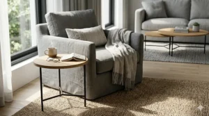 A multi-functional living room layout showing the smaller piece of a nesting coffee table set repurposed as a standalone side table next to an armchair.