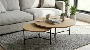 An illustration of industrial-style round nesting coffee tables featuring natural oak wood tops and black metal legs.