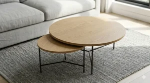 An illustration demonstrating the space-saving design of small nesting tables fully tucked beneath the larger main coffee table.