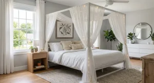 Boho style white metal canopy bed frame under $500 draped with sheer curtains and fairy lights.
