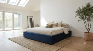 King size low-profile upholstered bed frame in a spacious master bedroom without a headboard.