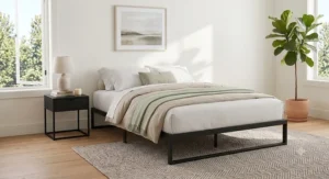 Minimalist black metal no-boxspring bed frame holding a queen platform mattress in a contemporary bedroom.