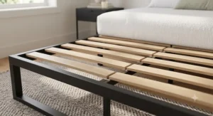Detailed close-up of sturdy wooden slats on a no-boxspring bed frame engineered for foam platform mattresses.